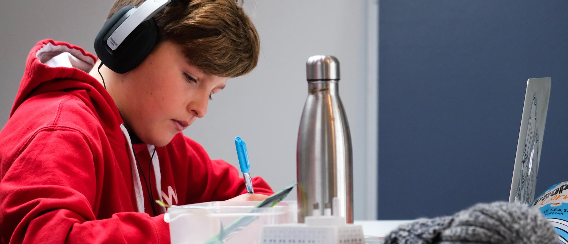 student with headphones is studying